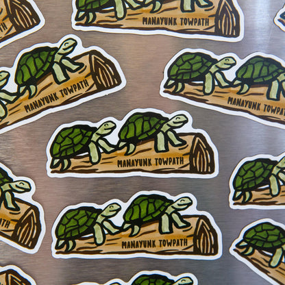 Mutiple turtle on a log magnets on a metallic background.