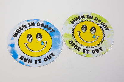 Two round stickers with smiley faces and text on a white background