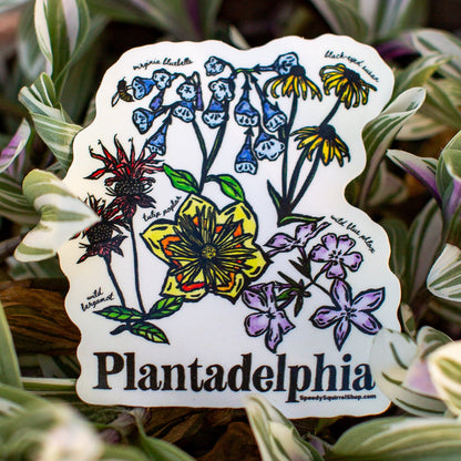 Sticker with colorful floral design and 'Plantadelphia' text with green leaves in the background.