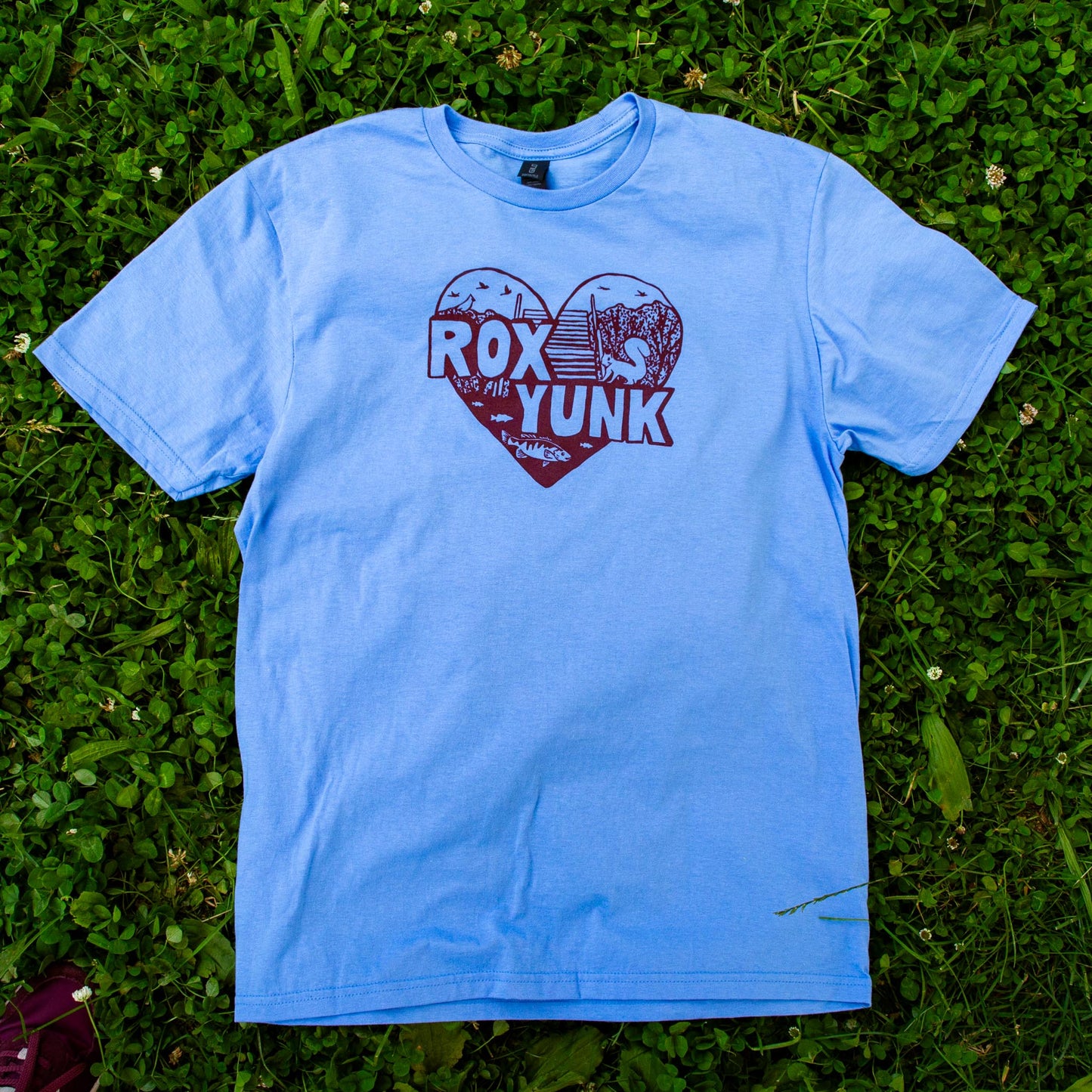 Heart-shaped design with 'ROX YUNK' text on a blue t-shirt