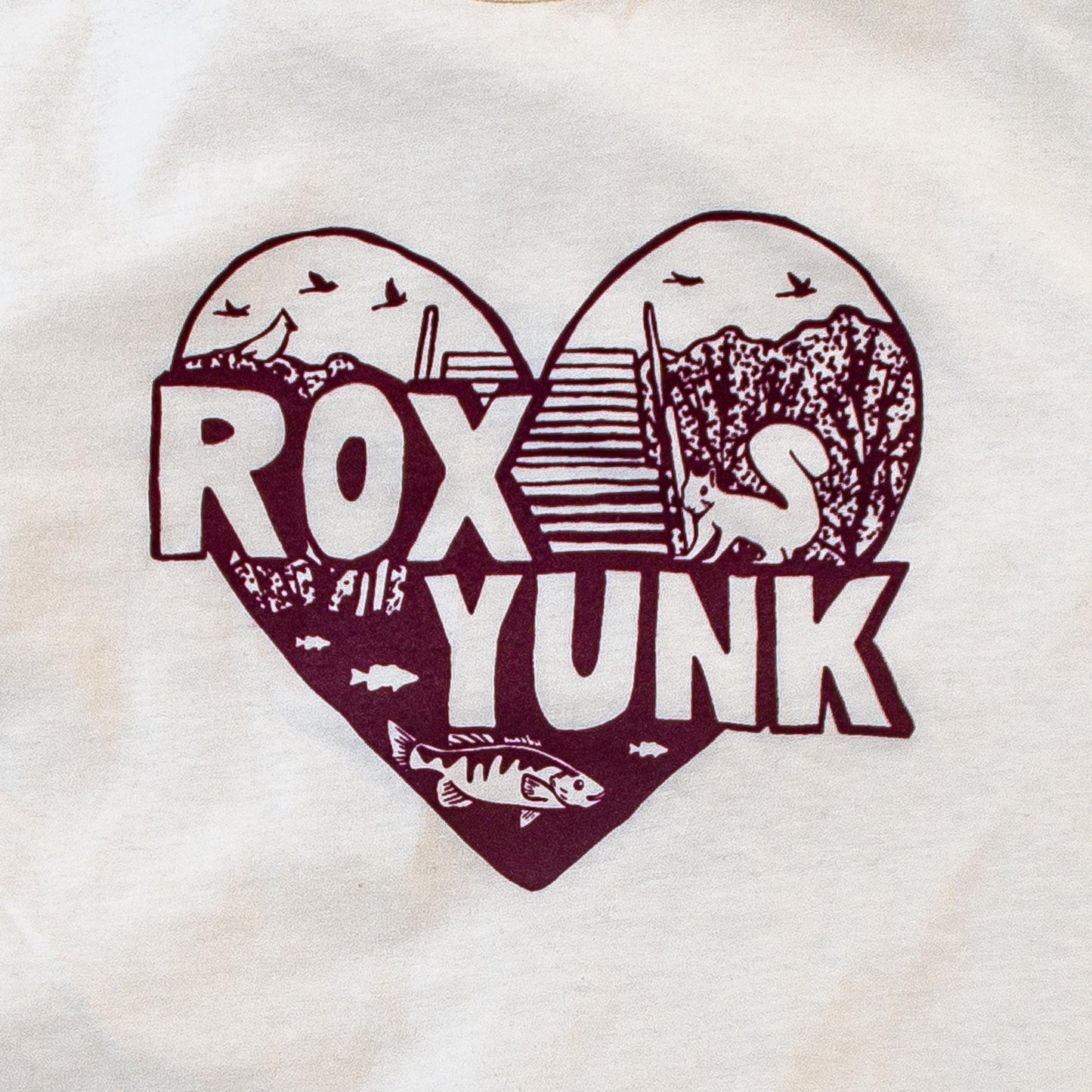 Heart-shaped design with 'ROX YUNK' text on a cream t-shirt