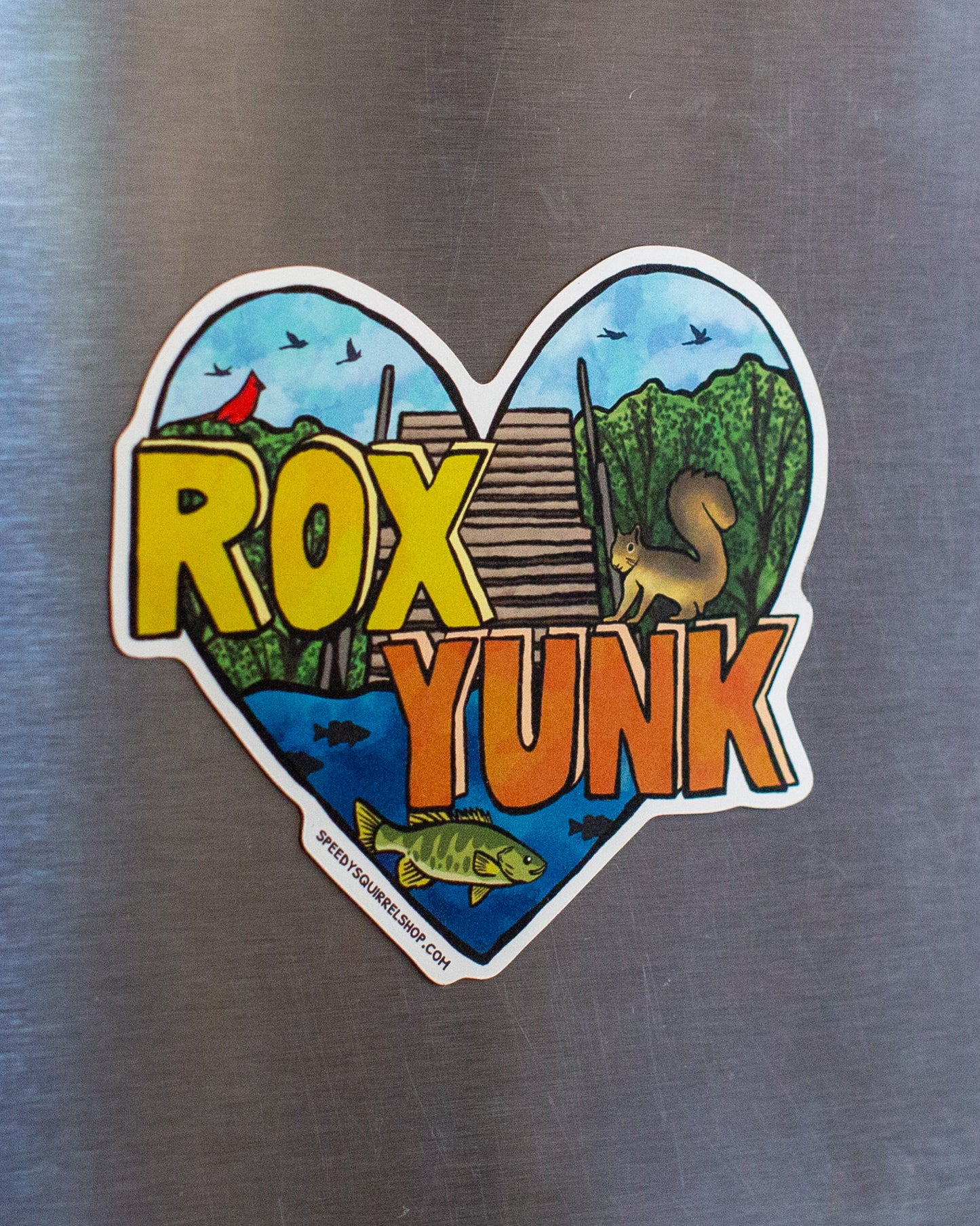 Heart-shaped sticker with 'ROX YUNK' text on a metallic surface