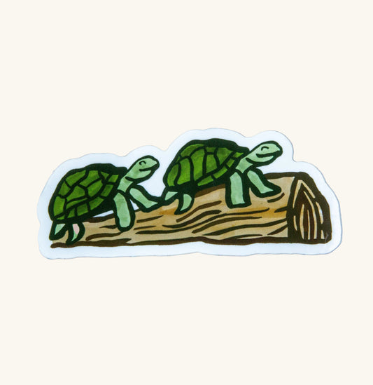 Two turtles smiling on a log sticker