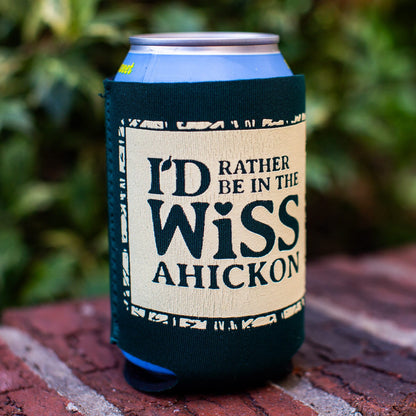 Can with a sleeve labeled 'I'd Rather Be in the Wissahickon' on a brick surface with greenery in the background