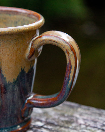 Close-up of a ceramic mug with a handle on a natural background