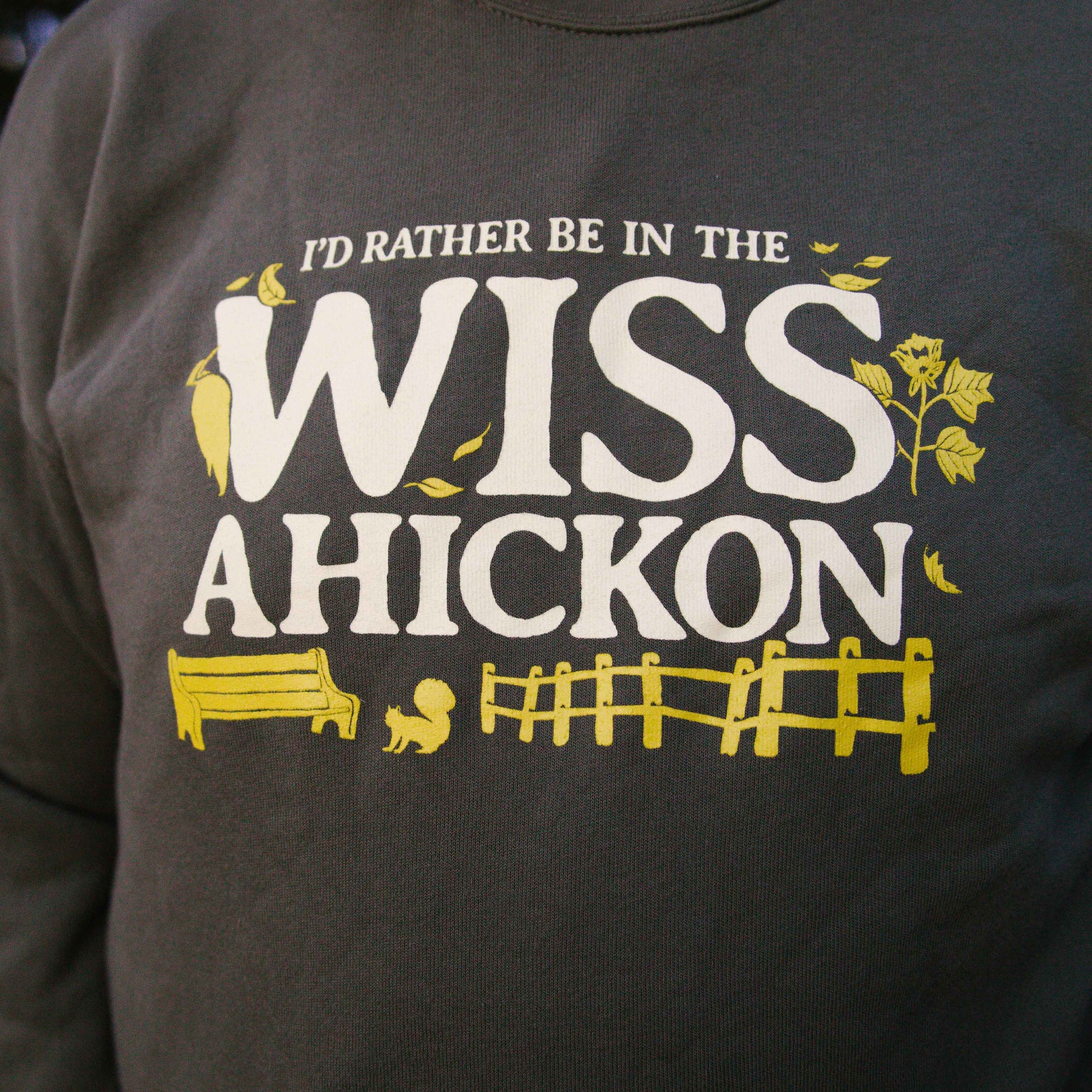 Olive crewneck with 'I'd Rather Be In The Wissahickon' text and graphics.